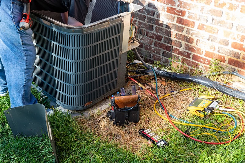 maintenance being performed on an air conditioner.